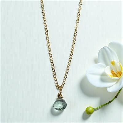 Delicate gold vermeil necklace with petite faceted semi-precious blue topaz gem